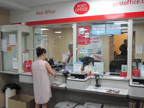 Customer depositing cash with secure banking services at Shires Post Office Leicester